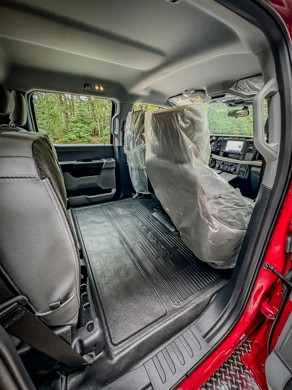 Rear floor and seatback view from open rear door.