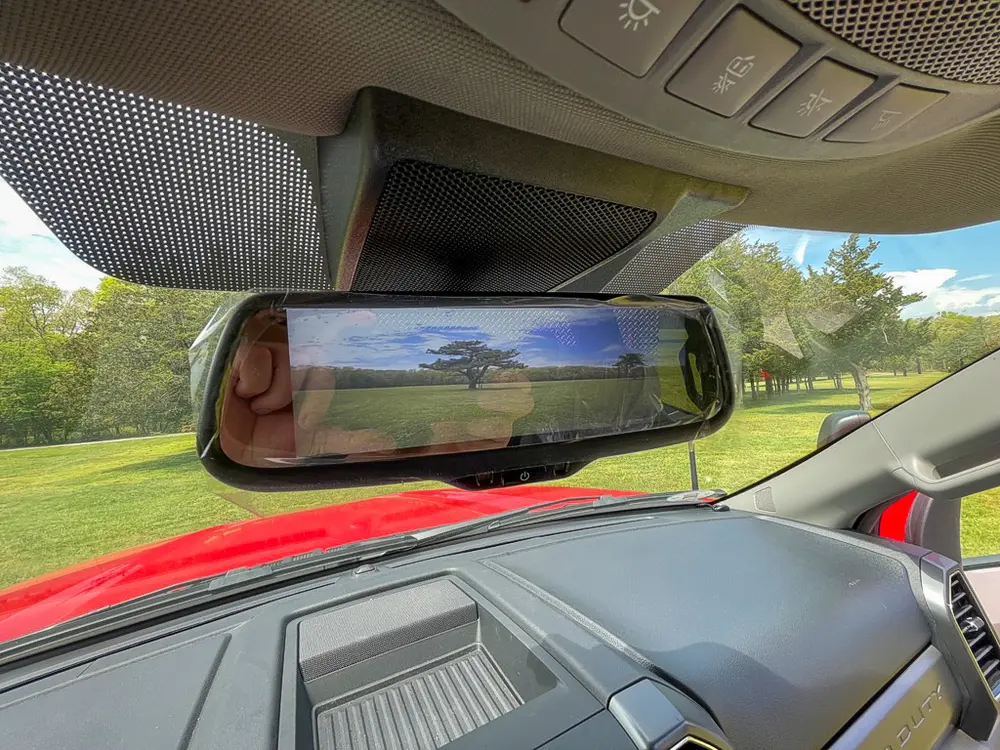 Exterior view of small fire truck showing cab, body compartments, and wheel/tire area.