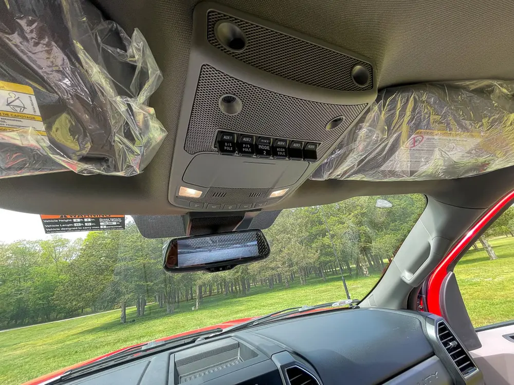 Exterior view of small fire truck showing cab, body compartments, and wheel/tire area.