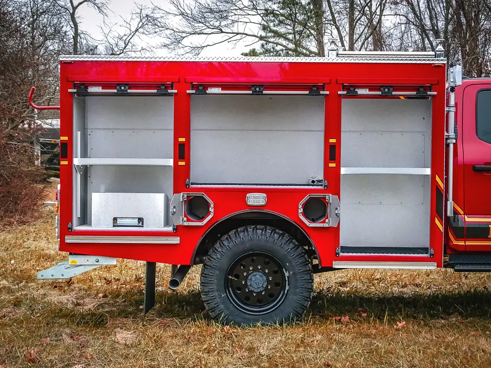 Close-up of open left-side compartments near the rear wheel.