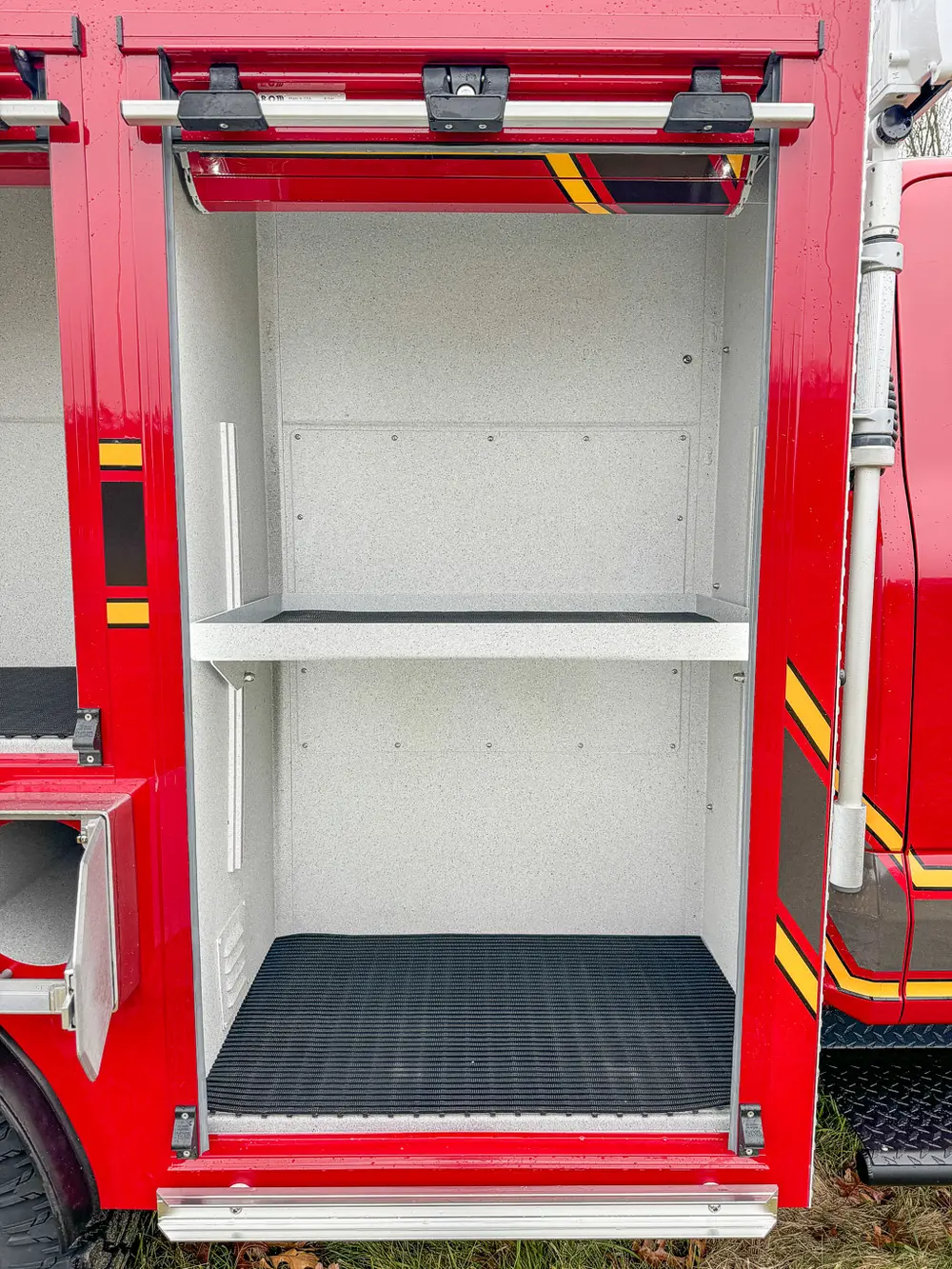 Interior view of a side compartment with two empty shelves.