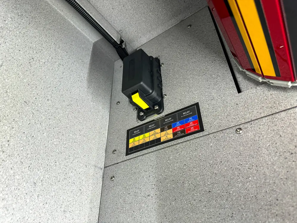 Close-up inside side compartment showing small mounted warning label.