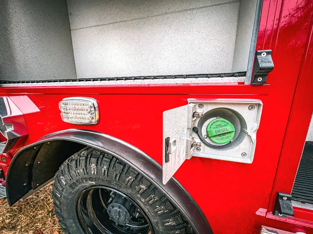 Lower side body close-up with wheel, marker light, and intake fitting.