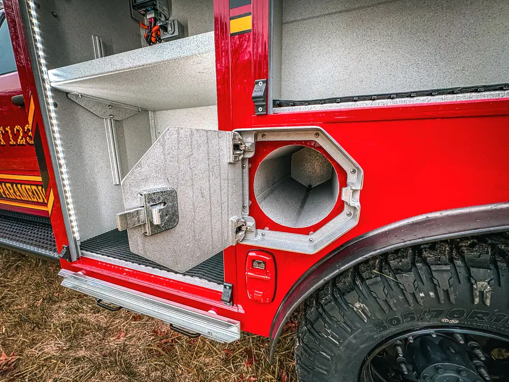 Open lower side compartment with large intake port and mounting bracket.