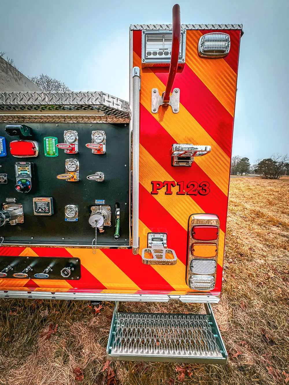 Rear-right corner view showing open pump panel and taillight cluster.
