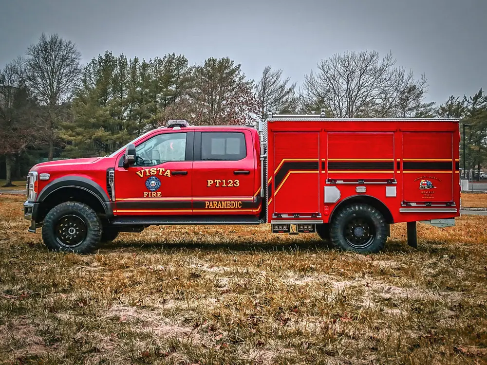 Full left-side profile of the truck parked on grass.