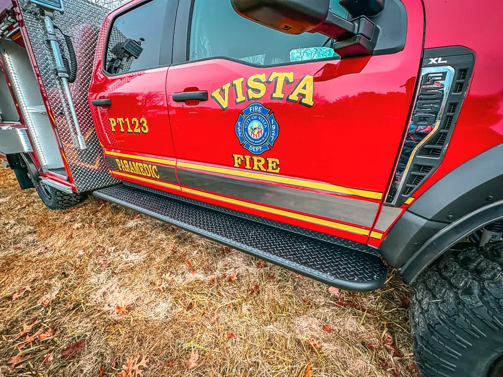 Cab side profile close-up with door graphics and front wheel.