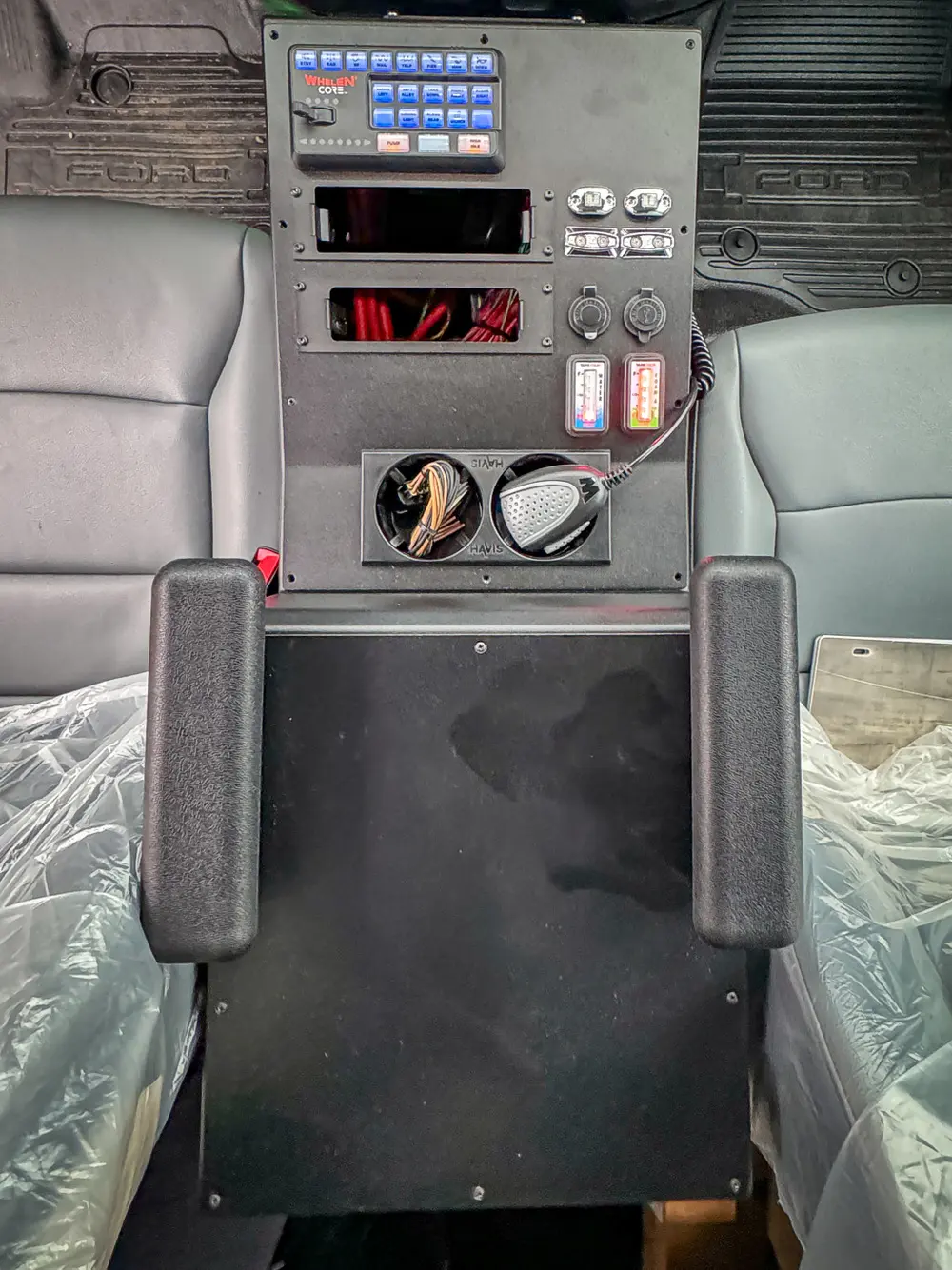 Rear center console close-up with dials and control knobs.