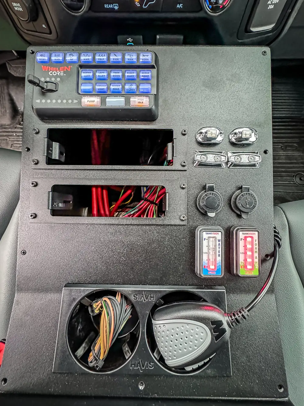 Interior side control panel close-up with switches, wiring, and indicators.