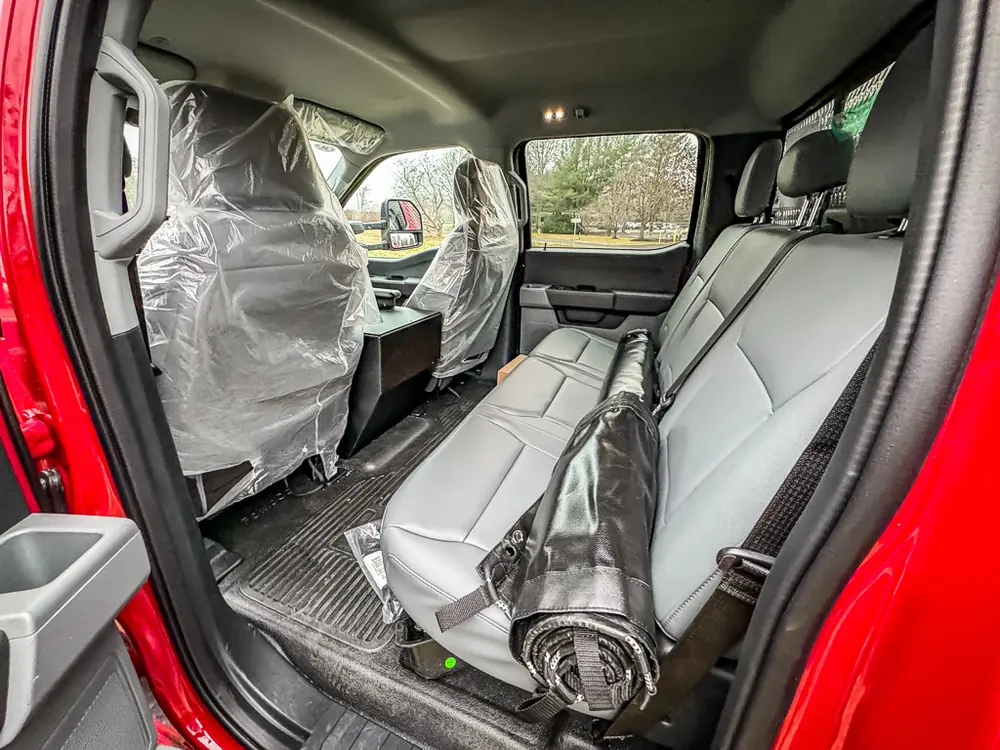 Rear cabin view showing bench seat and open rear door.