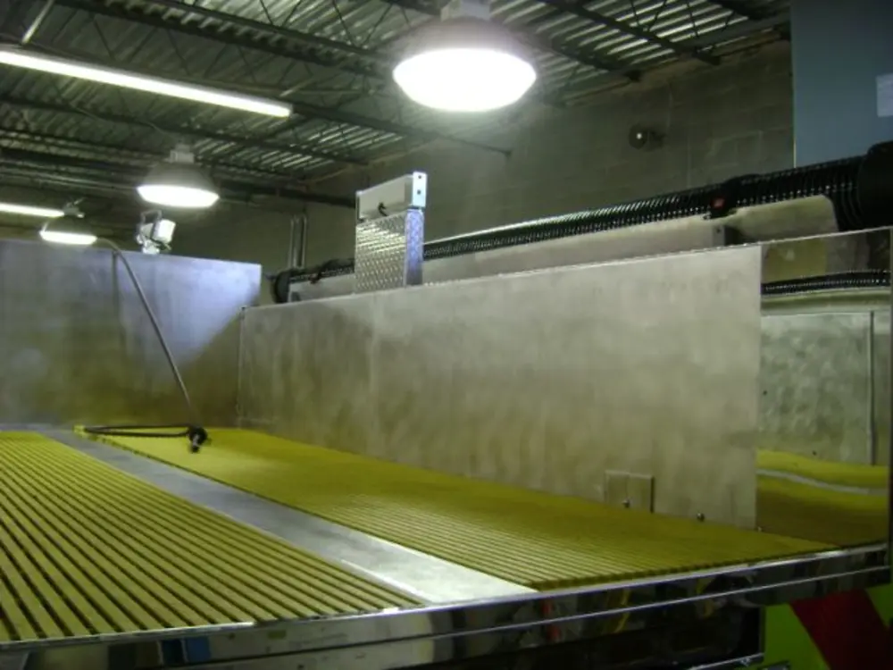 Exterior view of small fire truck showing cab, body compartments, and wheel/tire area.