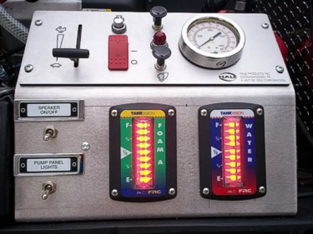 Exterior view of small fire truck showing cab, body compartments, and wheel/tire area.