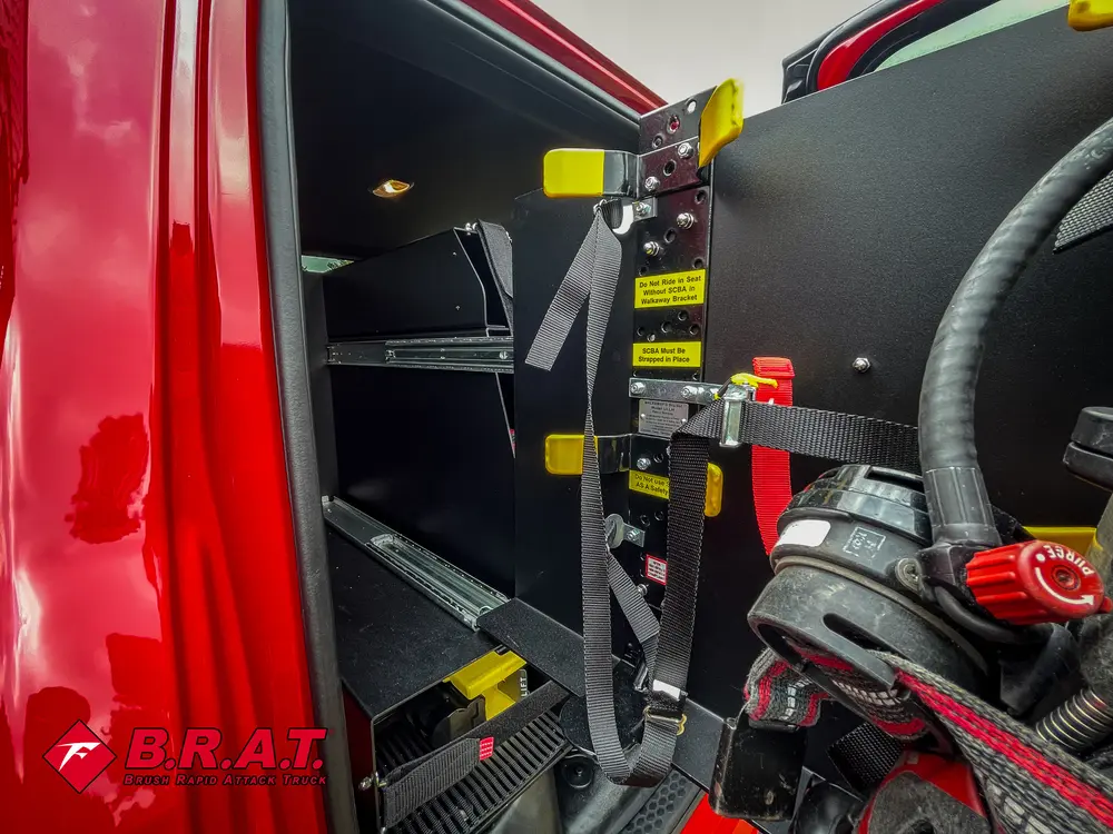 Rear seat equipment close-up showing mounted gear and floor bracket.