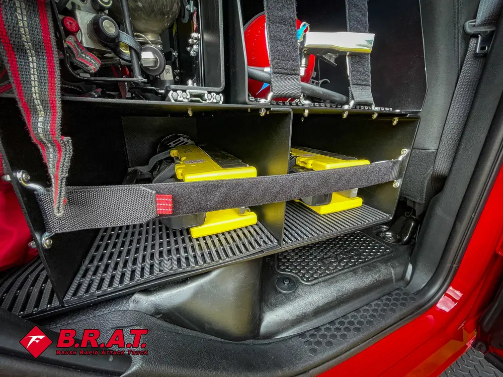 Rear cab floor area with shelves and mounted equipment behind seats.