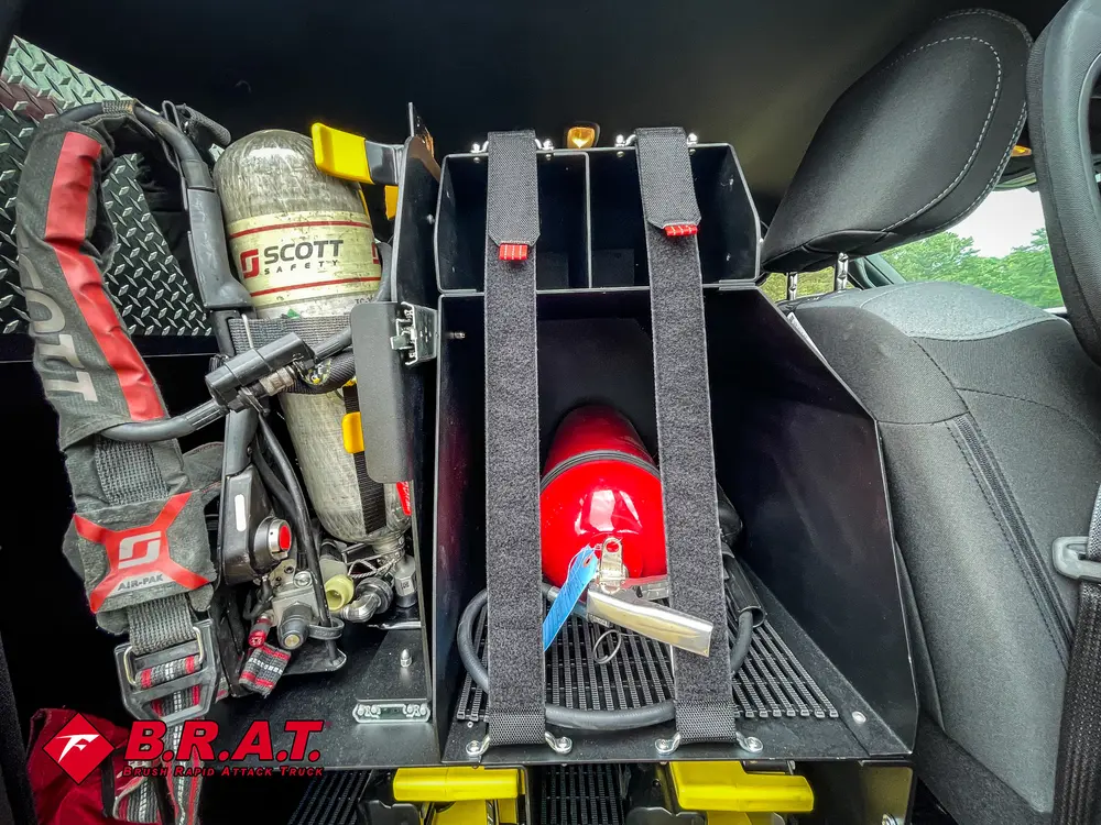Mounted gear rack close-up beside rear seat with extinguisher and tools.