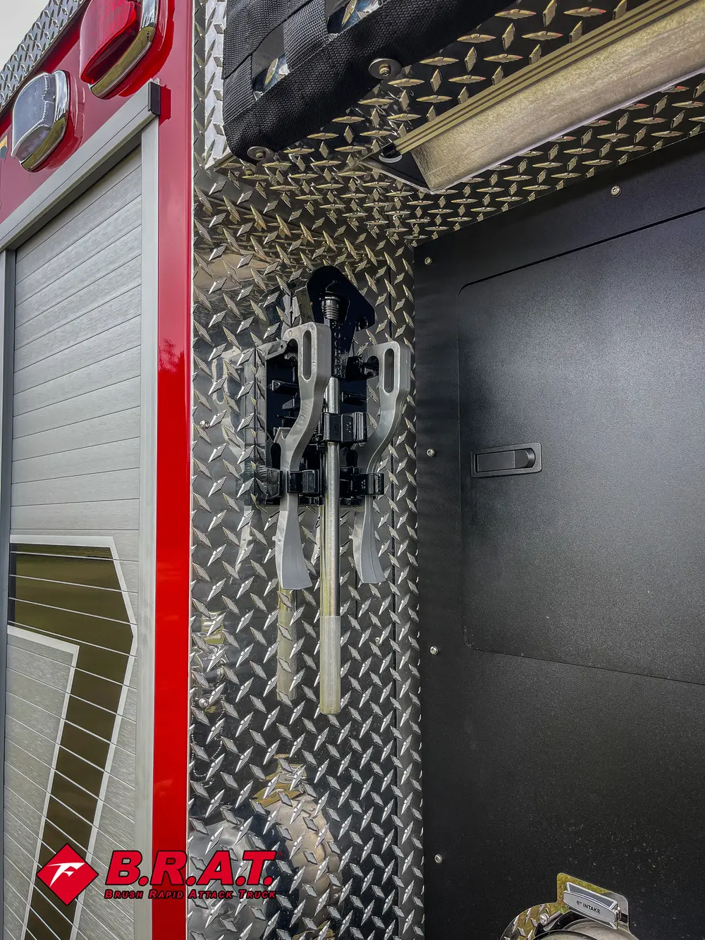 Vertical side compartment door with mounted hand tools and brackets.