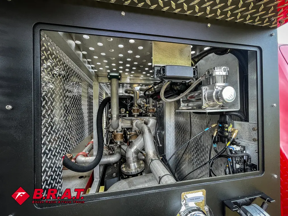 Pump compartment interior showing valves, hoses, and stainless plumbing.