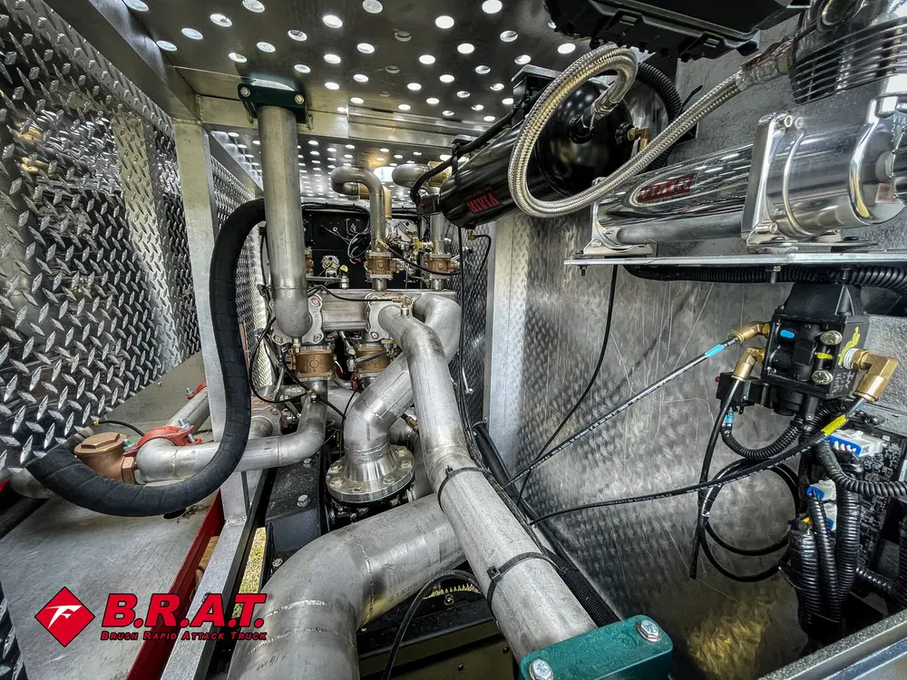 Pump plumbing close-up with valves and hose connections.