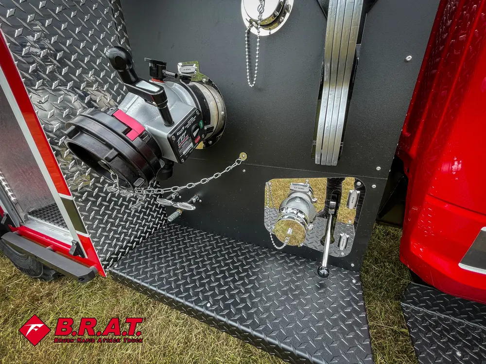 Pump panel close-up with large coupling and adjacent control ports.