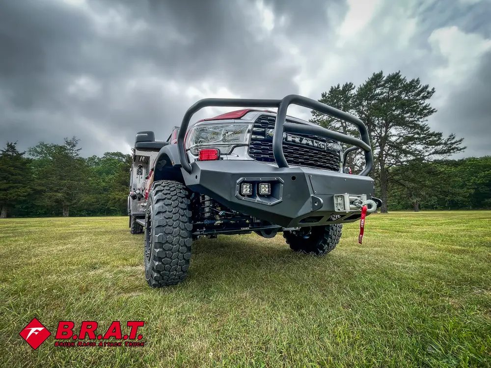 Low front-left angle emphasizing bumper, brush guard, and front tire.