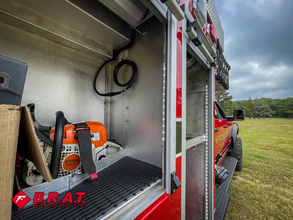 Wide open side compartment view with chainsaw and empty shelf space.