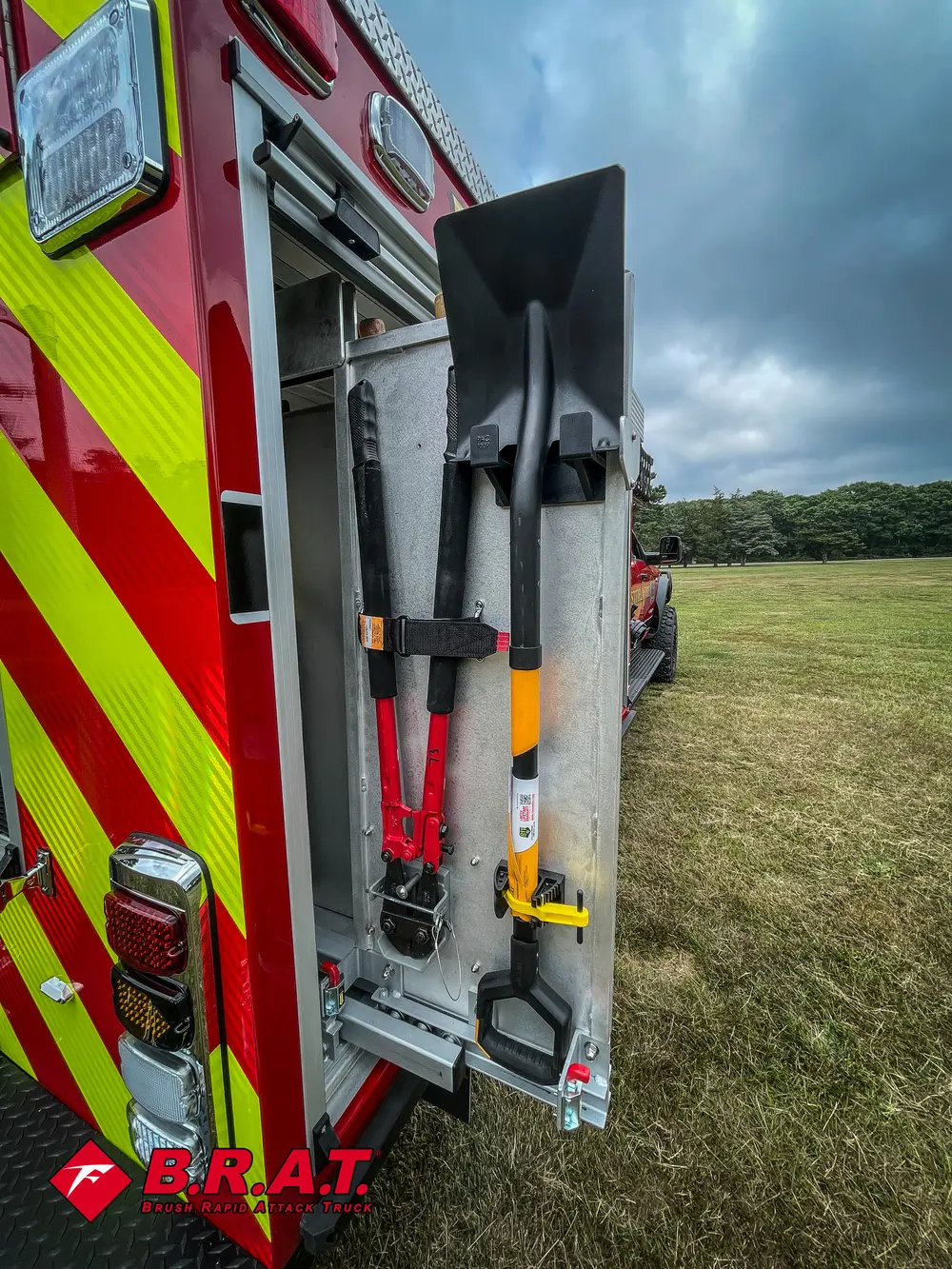 Rear side corner with mounted shovels and axes on external rack.