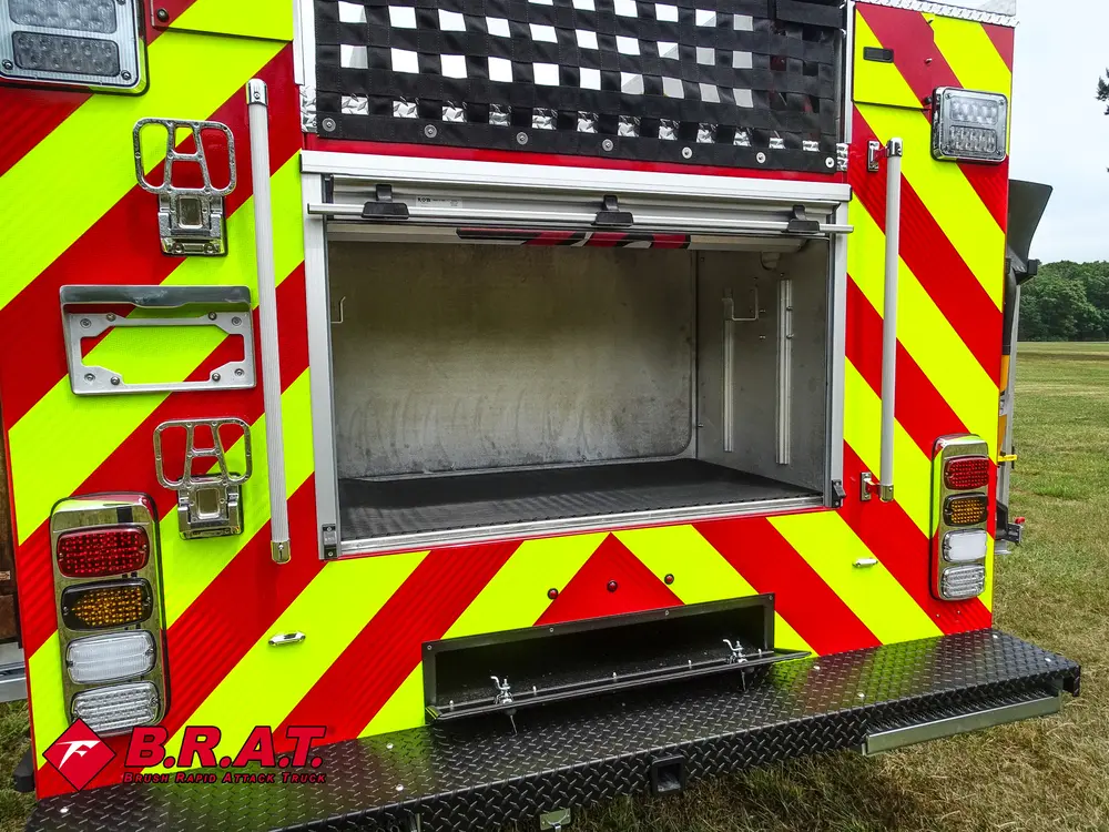 Rear center compartment open above fold-down rear step.