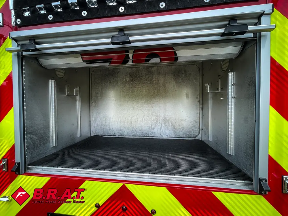 Rear compartment interior close-up with empty shelf and ribbed floor.