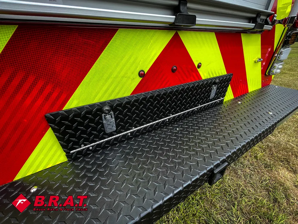 Fold-down rear step close-up with black anti-slip section.