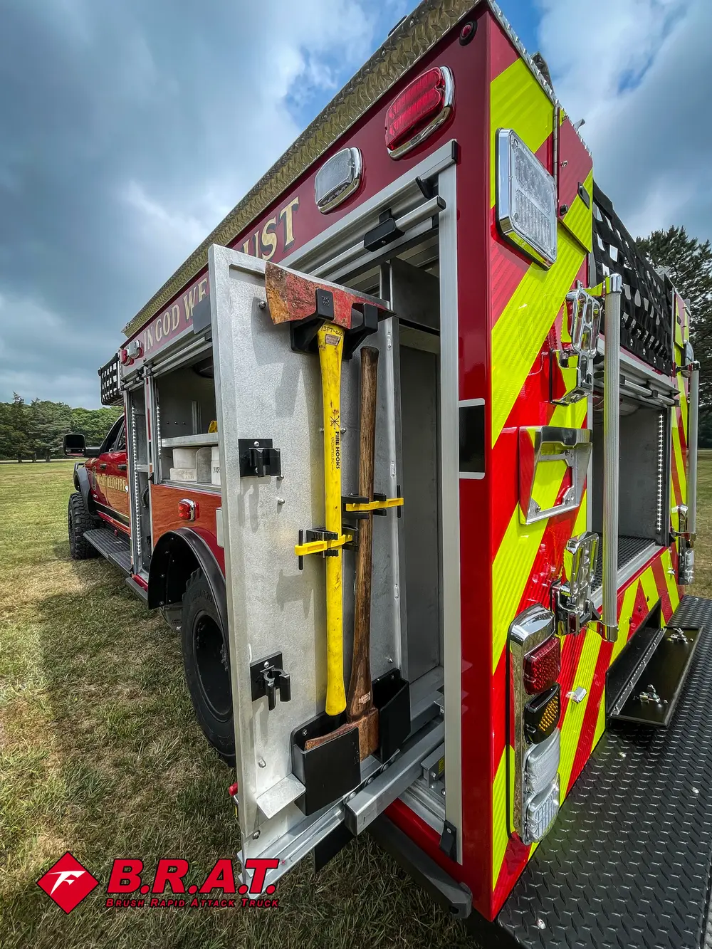 Rear-left side with mounted hand tools and open compartment doors.