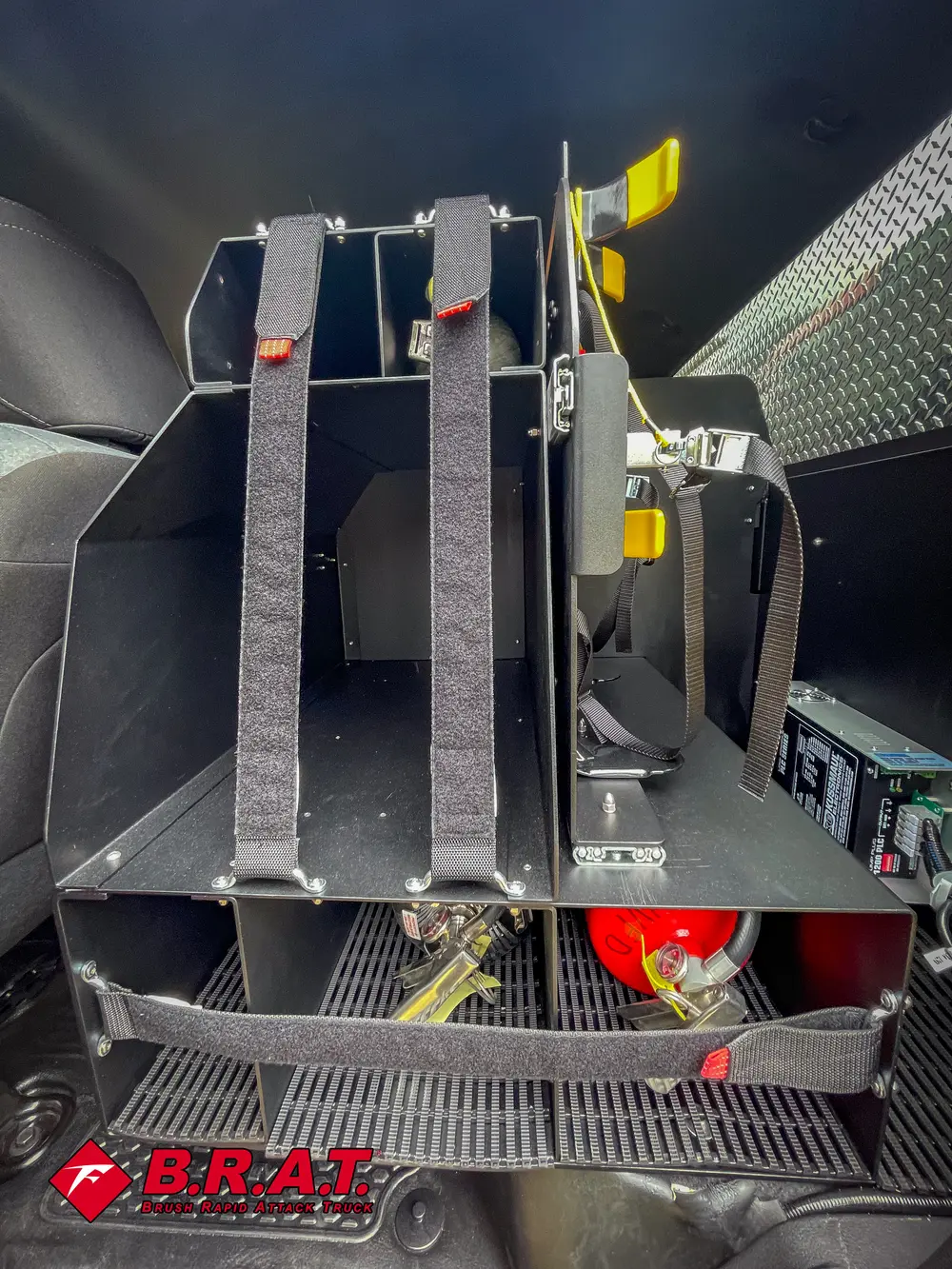 Rear cabin close-up showing tool mounting straps and storage bracket.