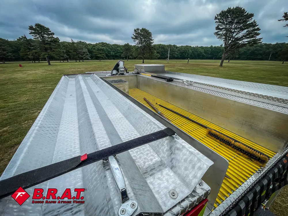 Top deck view along silver body panel and yellow grated walkway.