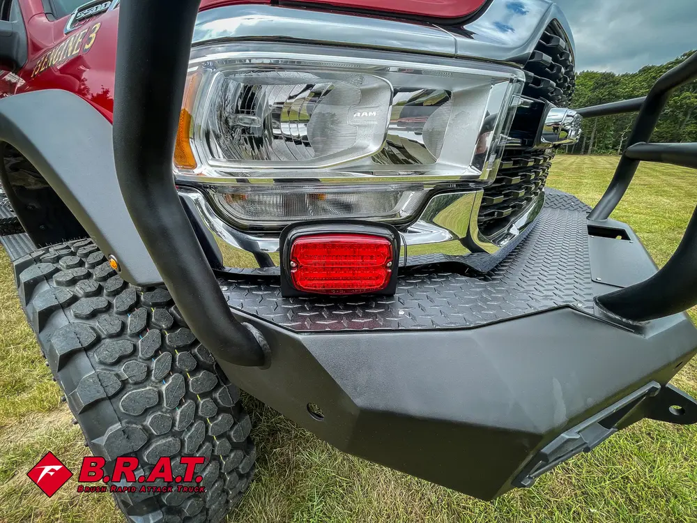 Front corner close-up with headlight cluster and bumper guard.