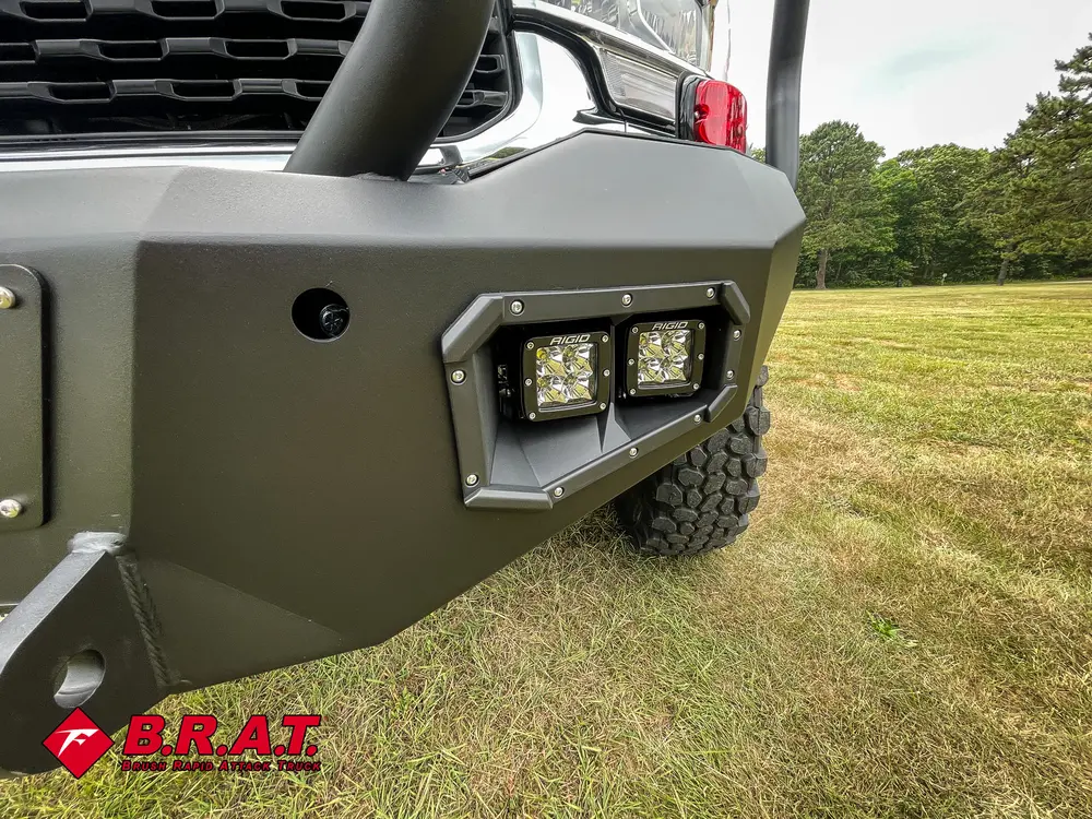 Front bumper side close-up with mounted auxiliary lights.