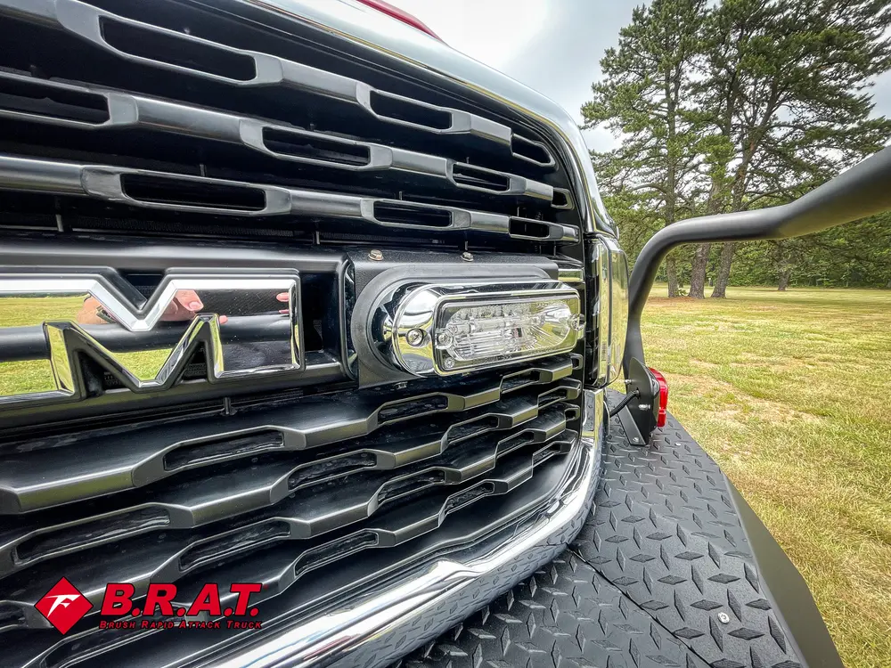 Grille close-up with center light bar and RAM emblem.