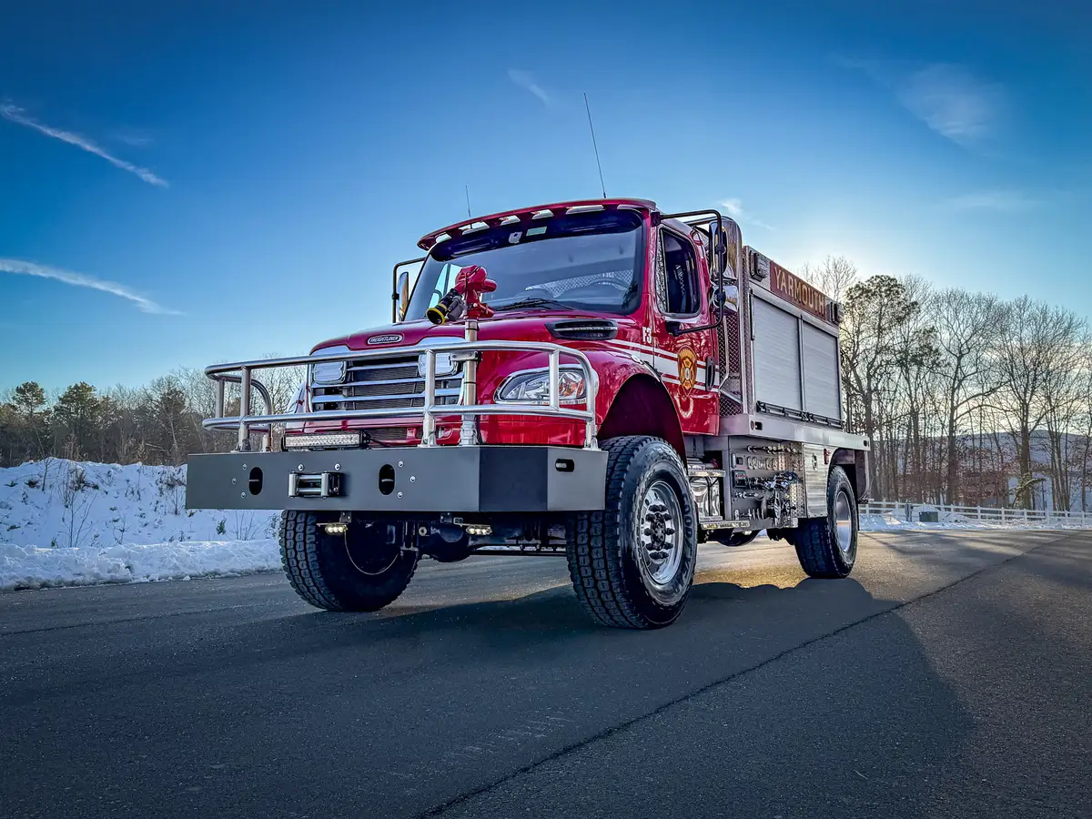 Low-angle front-left view emphasizing the bumper, brush guard, and front tire tread.