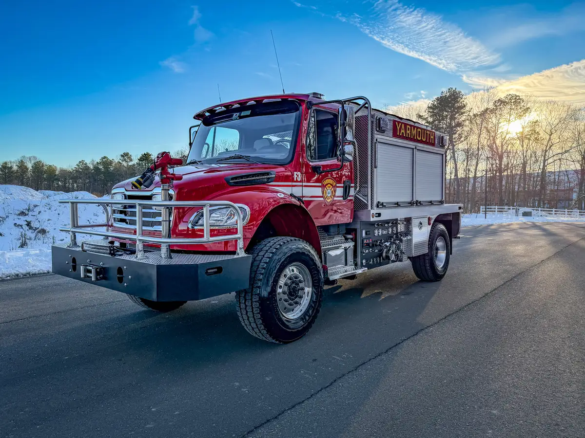 Front-left quarter exterior view showing cab, pump-panel section, and side compartments.