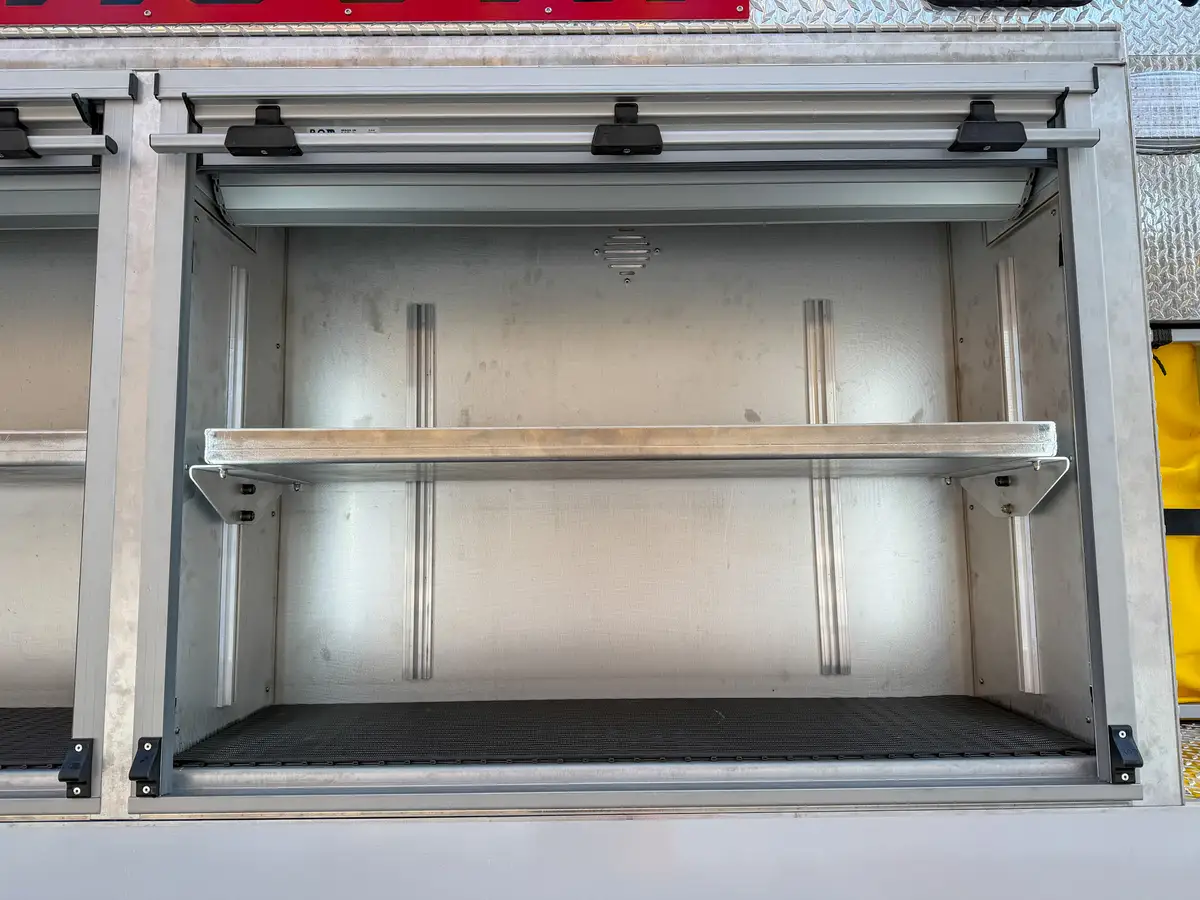 Close-up of the adjacent open upper side compartment with adjustable shelf.