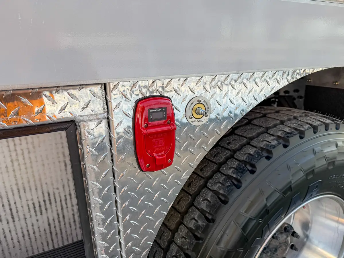 Close-up of the side body showing auto-eject port and air fitting by the rear wheel.