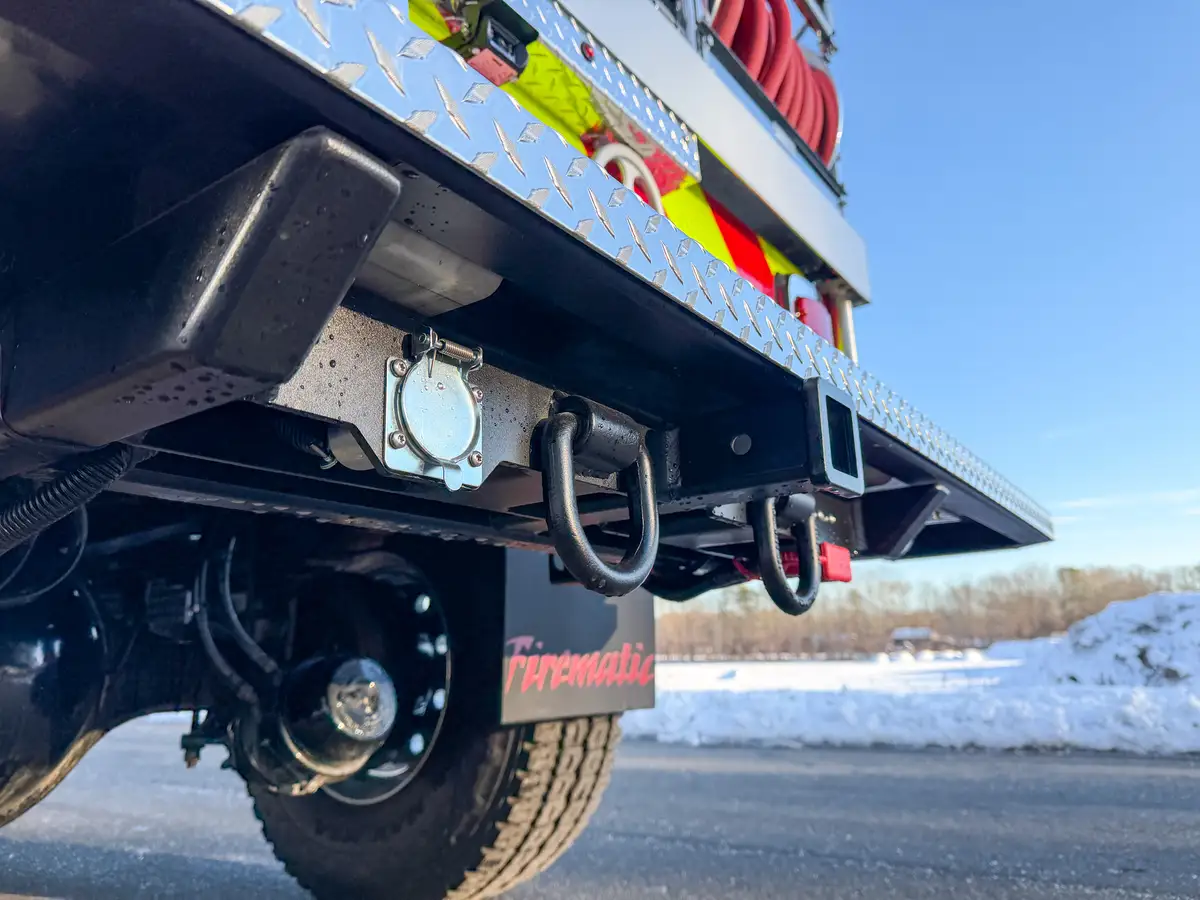 Underside rear bumper view showing tow points and trailer electrical connector.