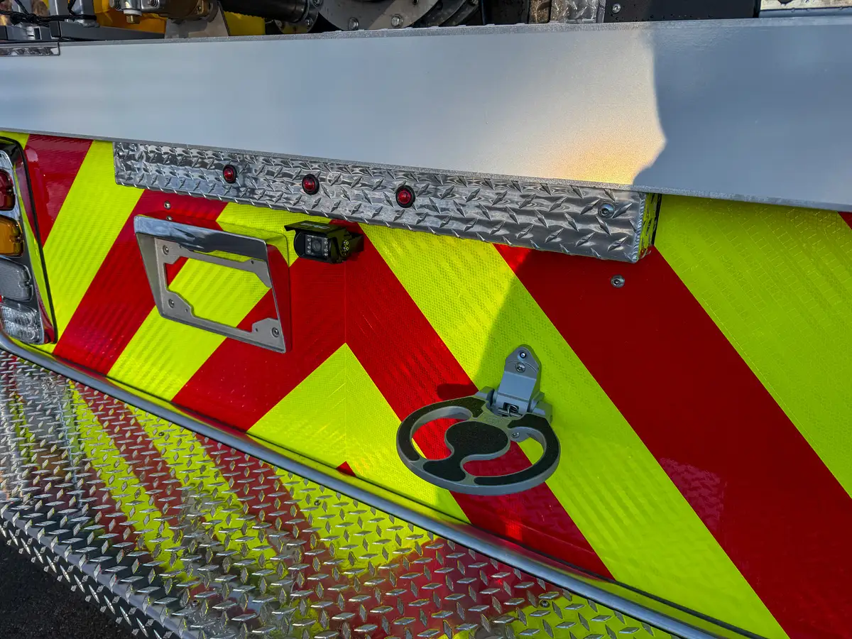 Rear chevron close-up with license mount, backup camera, and fold-down cup ring.