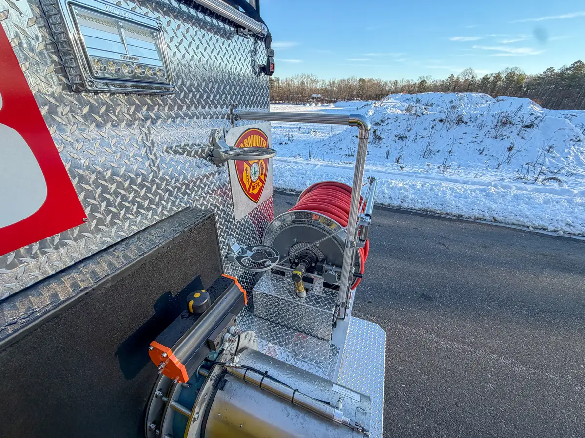 Elevated rear-corner view over hose reel and rear platform.