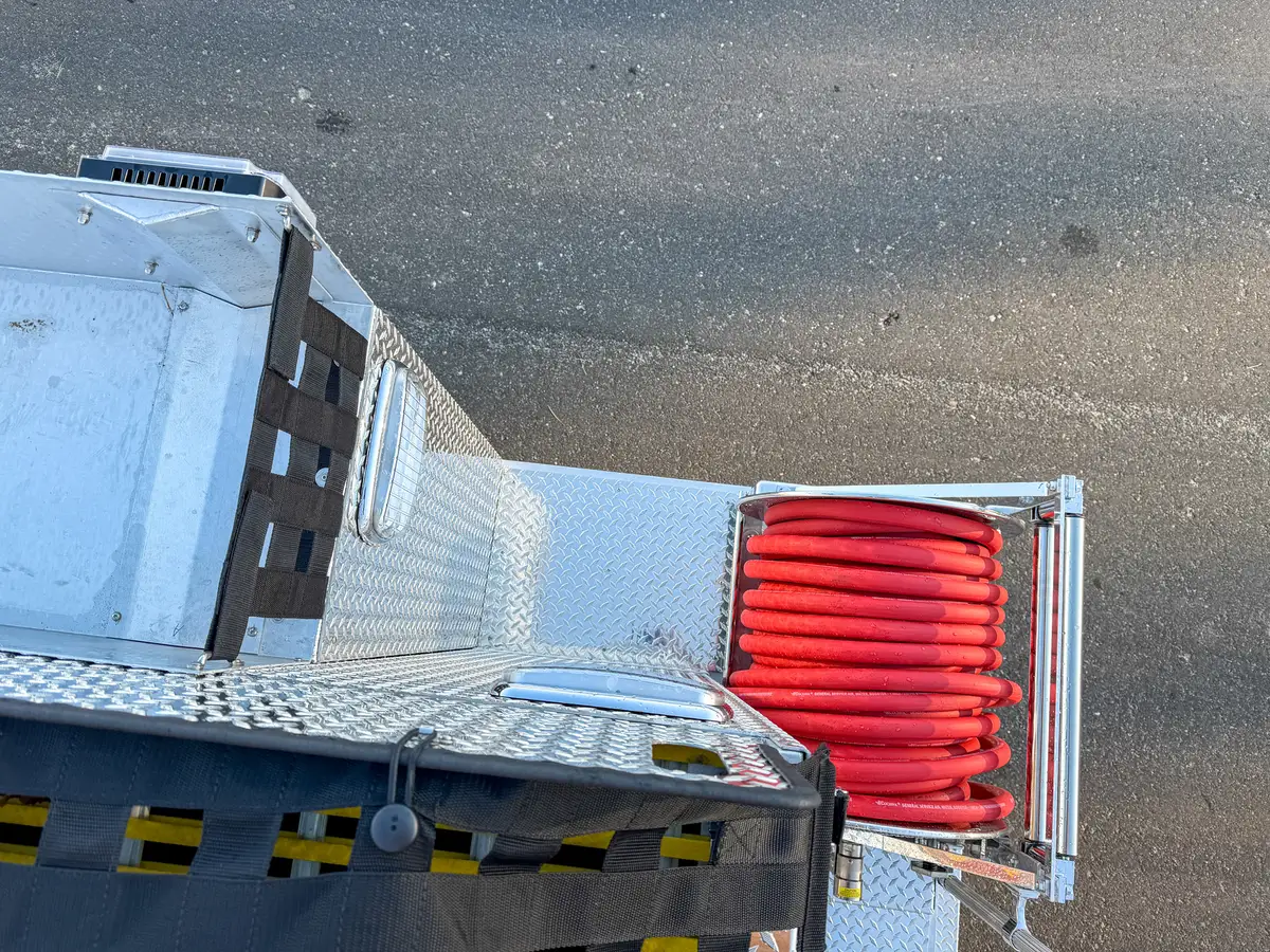 Top-down rear-corner view showing hose reel position below the upper deck.