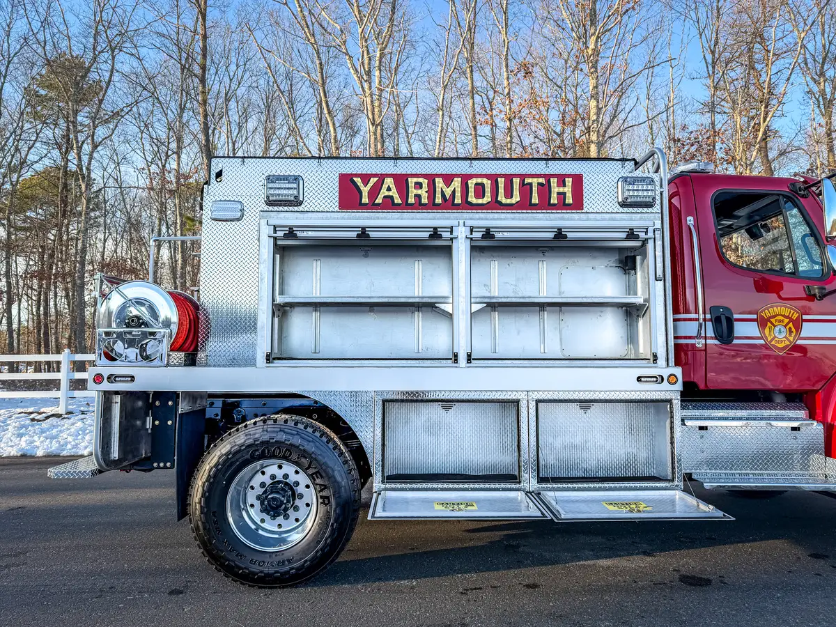 Right side profile with upper and lower compartments open for equipment access.