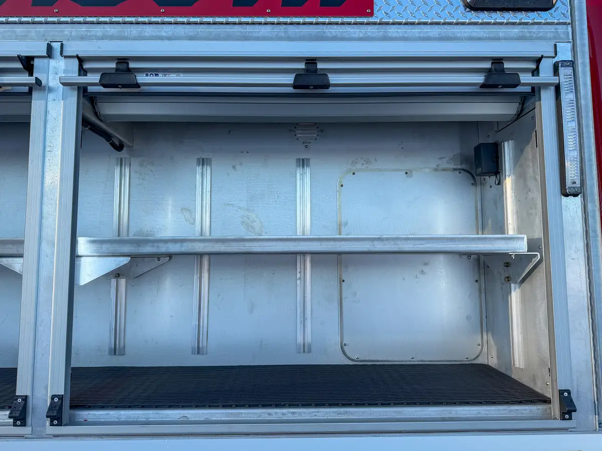 Close-up of adjacent open upper compartment shelf and side warning light.