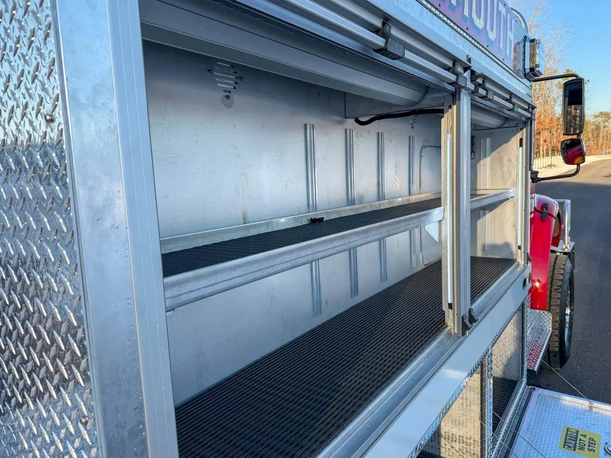 Angled view through open right-side upper compartments with long shelves.