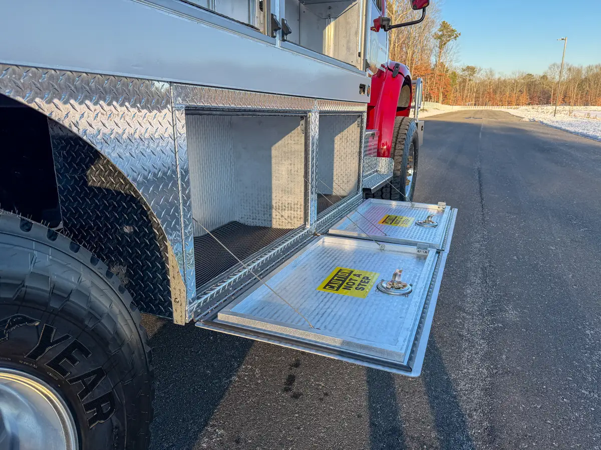View of open lower right-side compartments with fold-down doors.