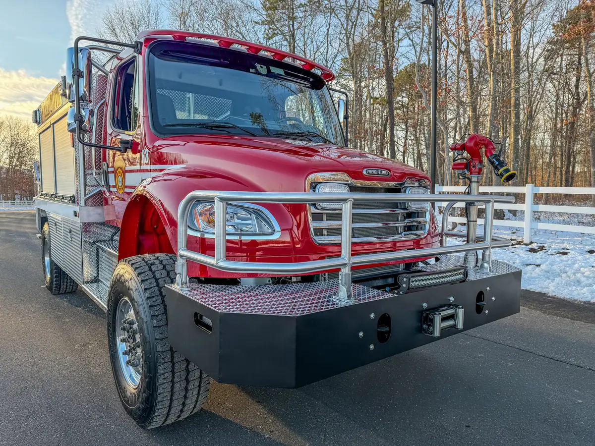 Front-left quarter close-up with brush guard, bumper, and front monitor assembly.