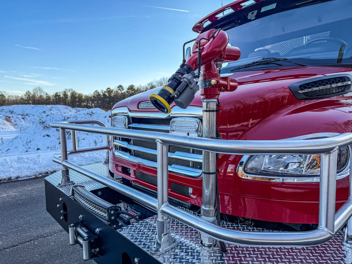 Close-up of bumper-mounted front monitor and nozzle assembly.