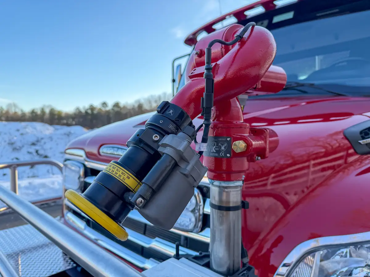 Close-up of front grille and warning lights behind the brush guard.